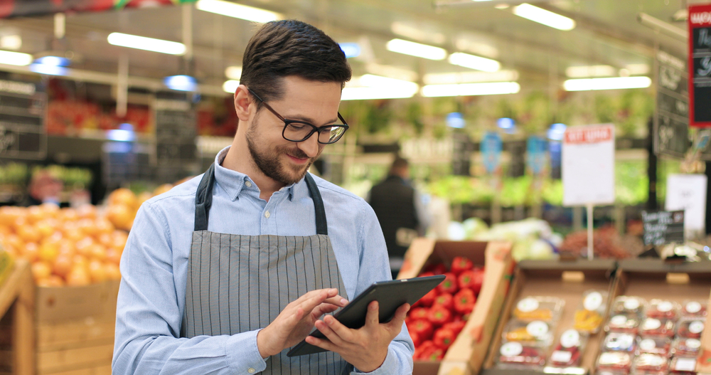 Grocery store manager using a tablet